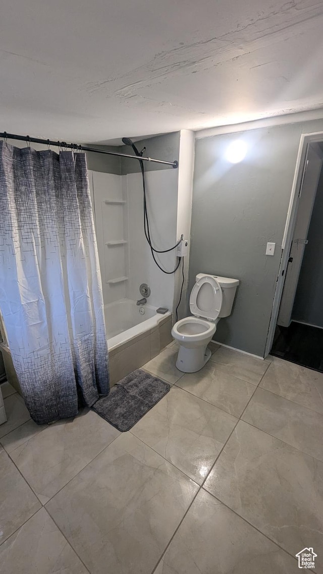 bathroom with toilet and shower / tub combo with curtain