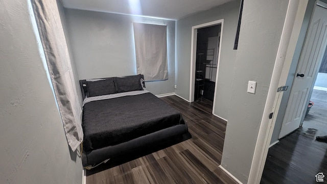 bedroom featuring dark wood finished floors
