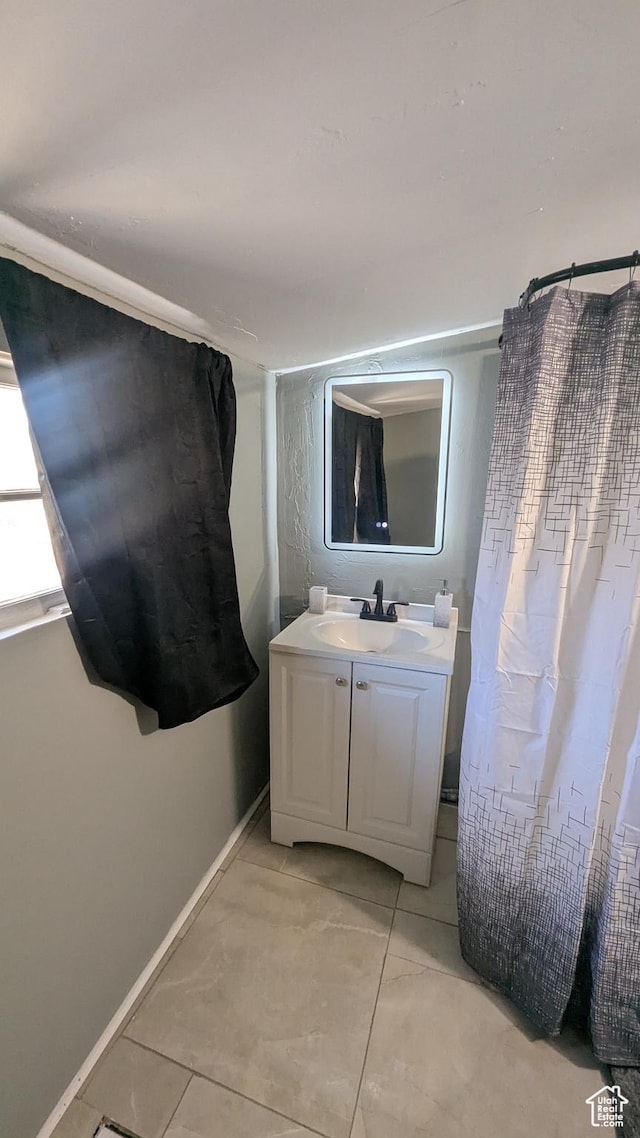 bathroom with vanity and baseboards