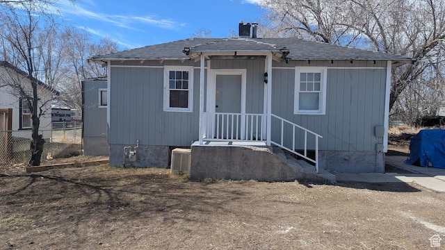 view of front of house featuring fence and central AC