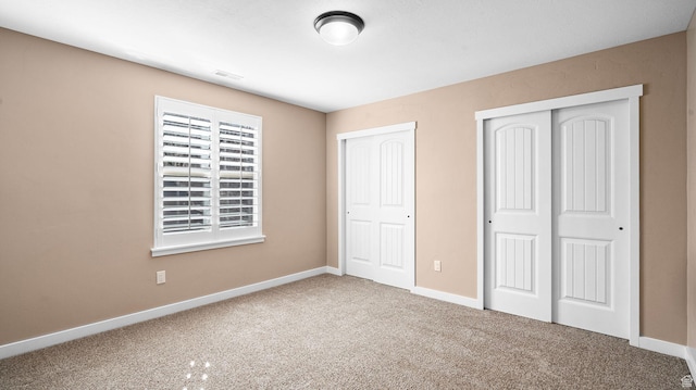 69 W Grove Creek Cir N, Farmington, UT 84025 - unfurnished bedroom featuring carpet flooring, baseboards, and two closets