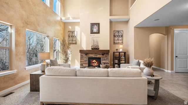 69 W Grove Creek Cir N, Farmington, UT 84025 - living room with a high ceiling, a fireplace, and baseboards