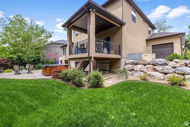 69 W Grove Creek Cir N, Farmington, UT 84025 - rear view of house with a hot tub, stucco siding, a yard, a patio area, and a garage