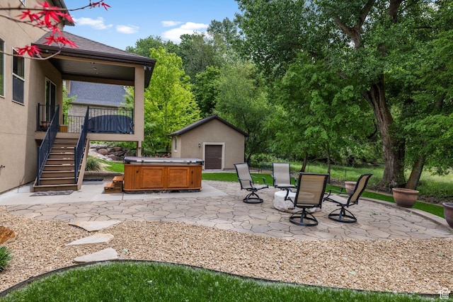 69 W Grove Creek Cir N, Farmington, UT 84025 - view of patio featuring a hot tub, stairs, an outdoor structure, and a wooden deck