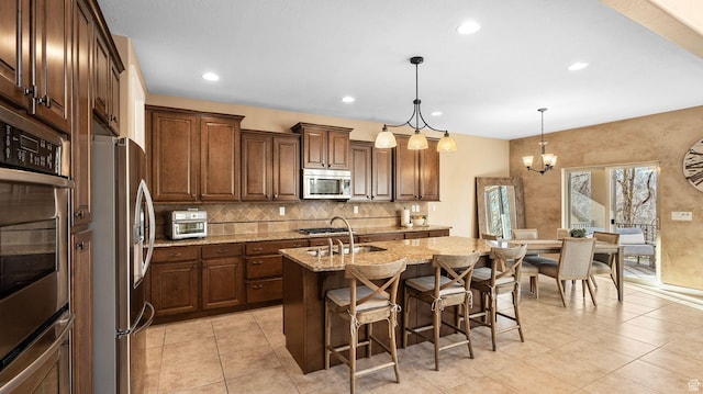 69 W Grove Creek Cir N, Farmington, UT 84025 - kitchen with appliances with stainless steel finishes, a sink, light stone counters, tasteful backsplash, and light tile patterned flooring