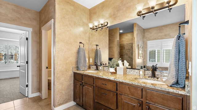 69 W Grove Creek Cir N, Farmington, UT 84025 - full bathroom featuring toilet, tile patterned floors, double vanity, tiled shower, and baseboards