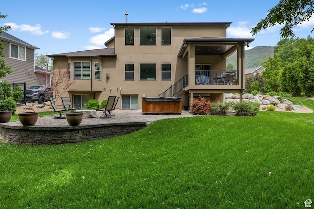 69 W Grove Creek Cir N, Farmington, UT 84025 - rear view of property with a hot tub, stucco siding, a patio, and a yard