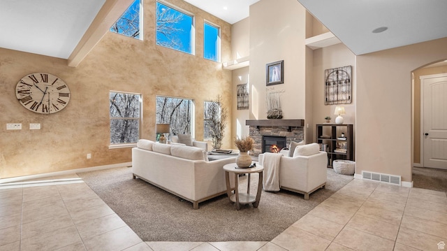 69 W Grove Creek Cir N, Farmington, UT 84025 - living area with baseboards, a stone fireplace, tile patterned floors, healthy amount of natural light, and a high ceiling