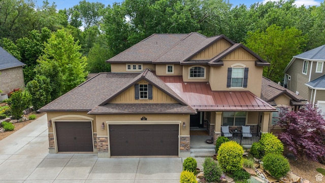 69 W Grove Creek Cir N, Farmington, UT 84025 - craftsman house featuring stucco siding, stone siding, a porch, and roof with shingles