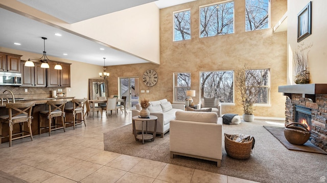 69 W Grove Creek Cir N, Farmington, UT 84025 - living area with a towering ceiling, a fireplace, recessed lighting, light tile patterned floors, and a chandelier