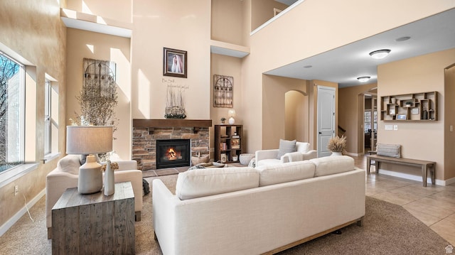 69 W Grove Creek Cir N, Farmington, UT 84025 - living room with a high ceiling, baseboards, a fireplace, and light tile patterned floors