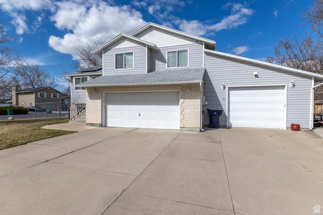 2350 N 720 W, Layton, UT 84041 - view of front of house with concrete driveway, an attached garage, and brick siding