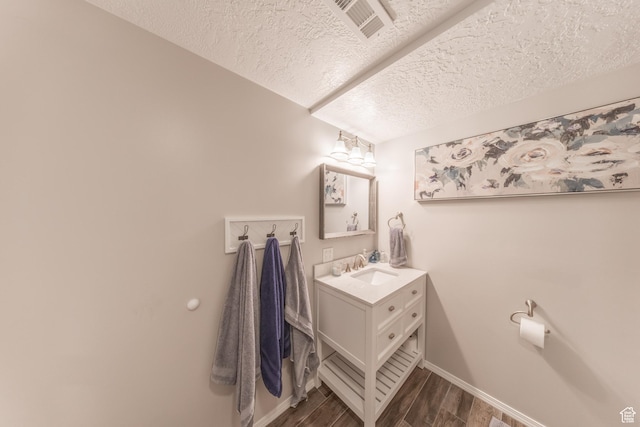 2350 N 720 W, Layton, UT 84041 - bathroom with wood finished floors, visible vents, vanity, baseboards, and a textured ceiling