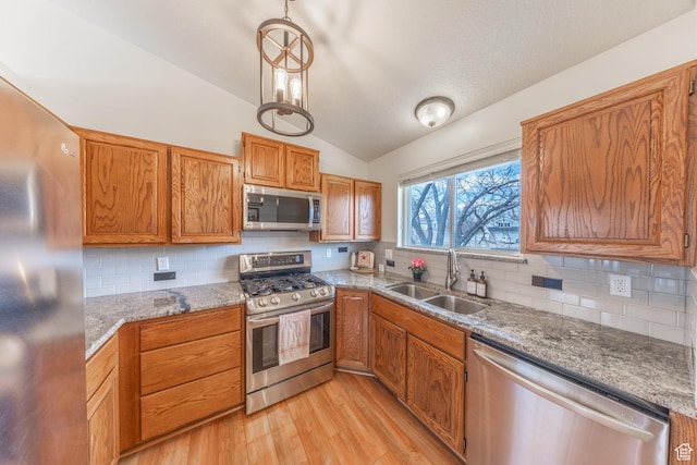 2350 N 720 W, Layton, UT 84041 - kitchen with lofted ceiling, stainless steel appliances, a sink, light wood-type flooring, and decorative backsplash