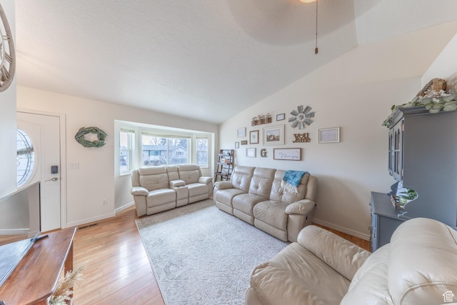 2350 N 720 W, Layton, UT 84041 - living room with light wood-style floors, lofted ceiling, and baseboards