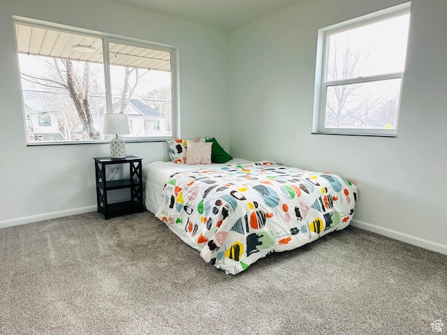 carpeted bedroom featuring baseboards