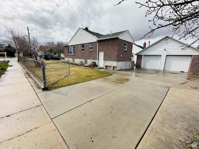 view of side of home with a lawn, fence, an outdoor structure, brick siding, and a chimney