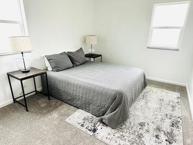 bedroom with carpet and baseboards