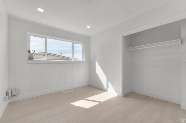 unfurnished bedroom with recessed lighting, a closet, baseboards, and light wood finished floors