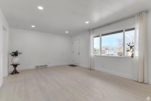 unfurnished room featuring recessed lighting, visible vents, and light wood-style floors