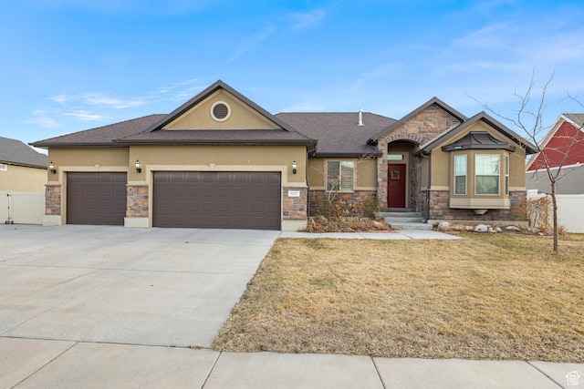 view of front facade featuring stucco siding, driveway, stone siding, fence, and an attached garage