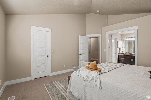 carpeted bedroom featuring vaulted ceiling, baseboards, visible vents, and ensuite bathroom