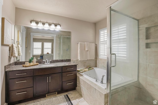 ensuite bathroom featuring visible vents, a garden tub, a stall shower, connected bathroom, and vanity