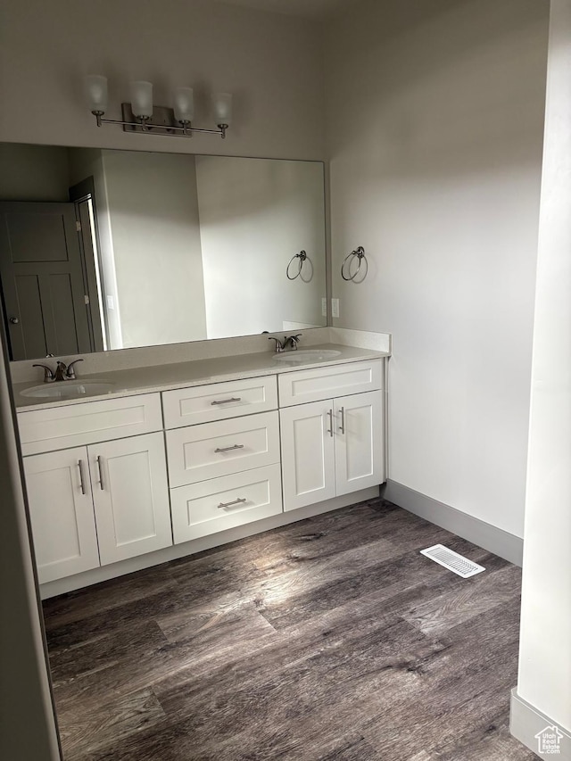 12734 S 1630 W, Riverton, UT 84065 - bathroom with wood finished floors, double vanity, a sink, and baseboards