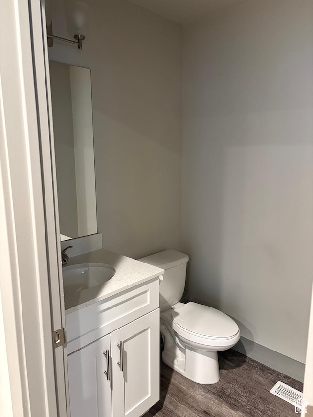 12734 S 1630 W, Riverton, UT 84065 - half bath with vanity, visible vents, toilet, and wood finished floors