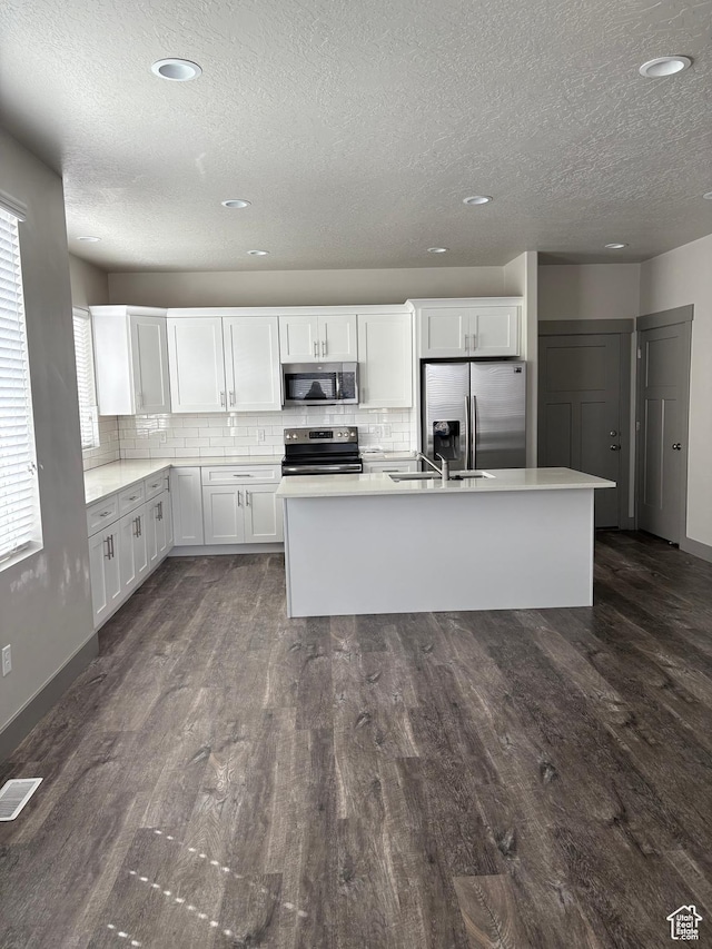 12734 S 1630 W, Riverton, UT 84065 - kitchen featuring visible vents, a sink, appliances with stainless steel finishes, dark wood-style floors, and a textured ceiling