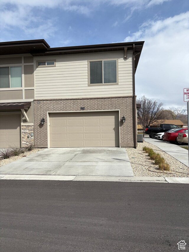 12734 S 1630 W, Riverton, UT 84065 - view of front of property with a garage, brick siding, and driveway