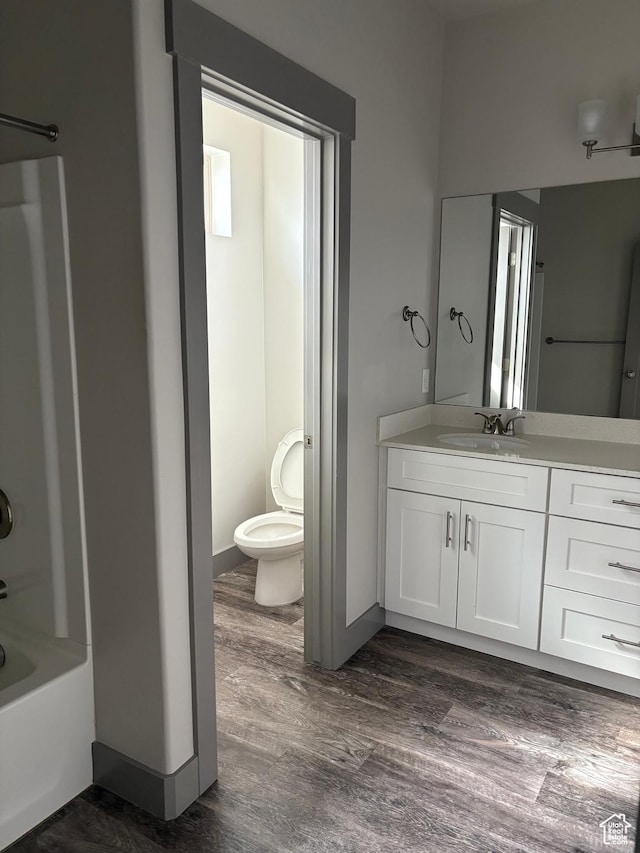 12734 S 1630 W, Riverton, UT 84065 - full bathroom featuring baseboards, toilet, vanity, wood finished floors, and shower / tub combination