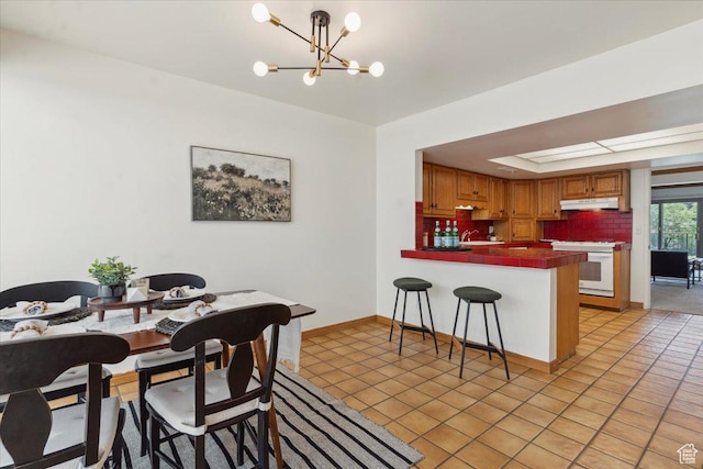 1231 E Brickyard Rd Unit 505, Millcreek, UT 84106 - dining area with a chandelier, light tile patterned floors, and a raised ceiling