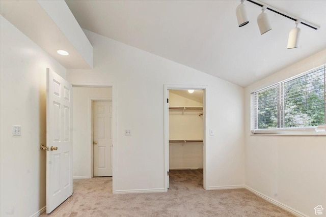 1231 E Brickyard Rd Unit 505, Millcreek, UT 84106 - unfurnished bedroom with carpet floors, vaulted ceiling, a walk in closet, and a closet