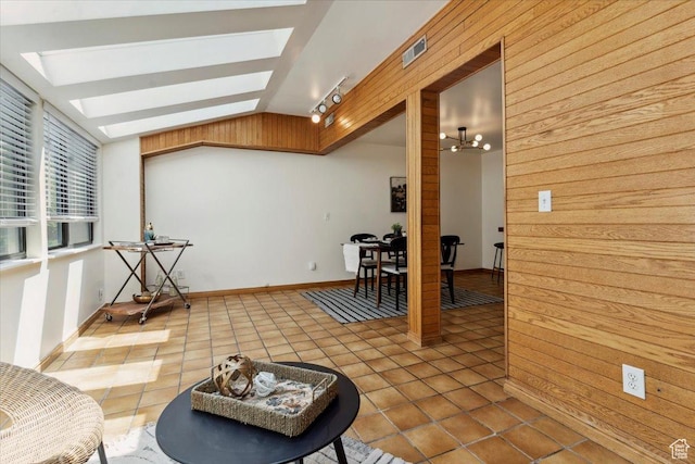 1231 E Brickyard Rd Unit 505, Millcreek, UT 84106 - living area featuring a skylight, lofted ceiling, tile patterned flooring, and wood walls