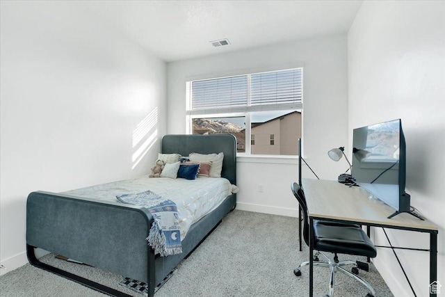 carpeted bedroom featuring visible vents and baseboards