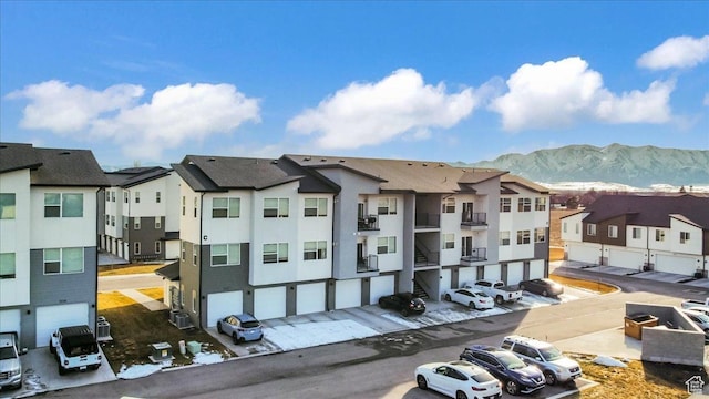 view of property with a mountain view and a residential view