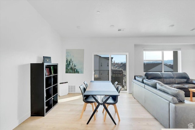 dining room featuring light wood-type flooring and visible vents