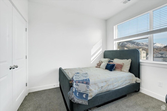 carpeted bedroom featuring visible vents and baseboards