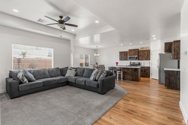 1639 E Yant Flant Dr, St George, UT 84790 - living room featuring visible vents, recessed lighting, ceiling fan with notable chandelier, and light wood-style floors