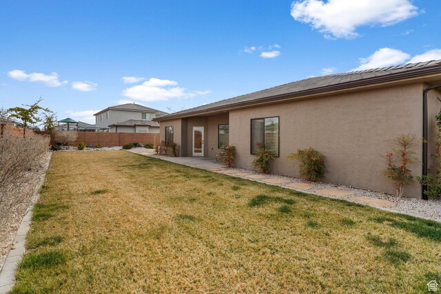 1639 E Yant Flant Dr, St George, UT 84790 - back of house with stucco siding, a patio, a yard, and fence