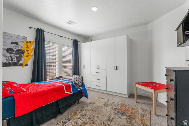 1639 E Yant Flant Dr, St George, UT 84790 - bedroom featuring light carpet, visible vents, a textured ceiling, and baseboards