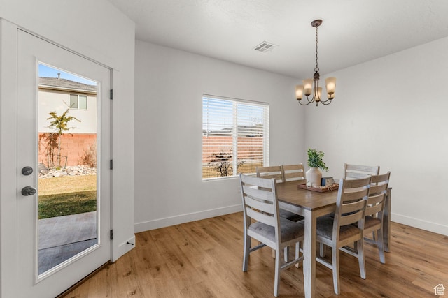 1639 E Yant Flant Dr, St George, UT 84790 - dining area with light wood-style flooring, a notable chandelier, and baseboards