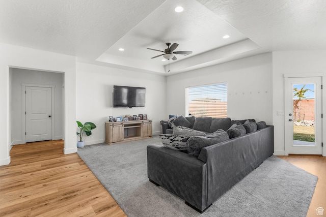 1639 E Yant Flant Dr, St George, UT 84790 - living room featuring a raised ceiling, a textured ceiling, recessed lighting, light wood finished floors, and baseboards