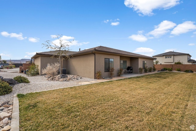 1639 E Yant Flant Dr, St George, UT 84790 - rear view of house with fence, a yard, stucco siding, central air condition unit, and a patio area