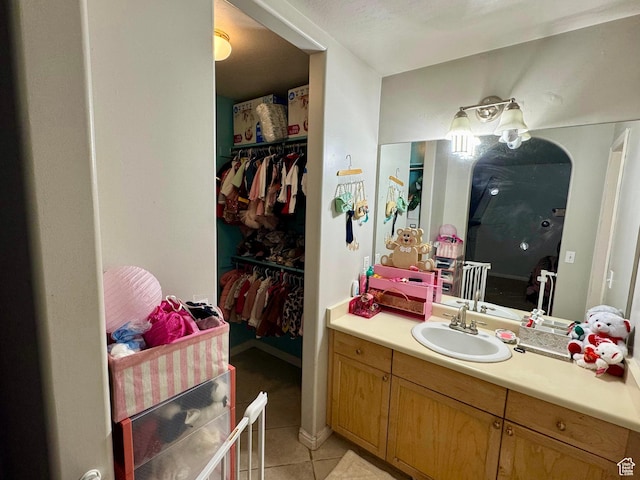173 W Dimaggio Dr N, Tooele, UT 84074 - bathroom with vanity, tile patterned floors, and a spacious closet