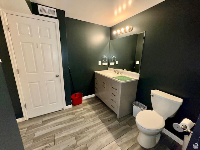 173 W Dimaggio Dr N, Tooele, UT 84074 - bathroom with visible vents, toilet, wood finished floors, baseboards, and vanity