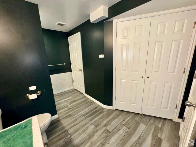 173 W Dimaggio Dr N, Tooele, UT 84074 - bathroom featuring toilet, wood finished floors, visible vents, and baseboards