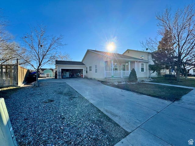 173 W Dimaggio Dr N, Tooele, UT 84074 - view of property exterior with an attached garage, covered porch, driveway, and fence