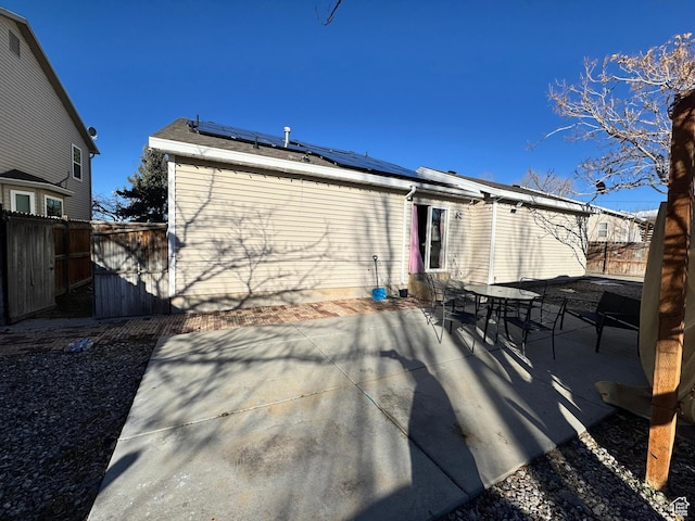 173 W Dimaggio Dr N, Tooele, UT 84074 - rear view of house featuring solar panels, a patio, and fence